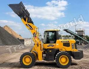 Yellow Massive 845 wheel loader with bucket raised, scooping gravel at a quarry site